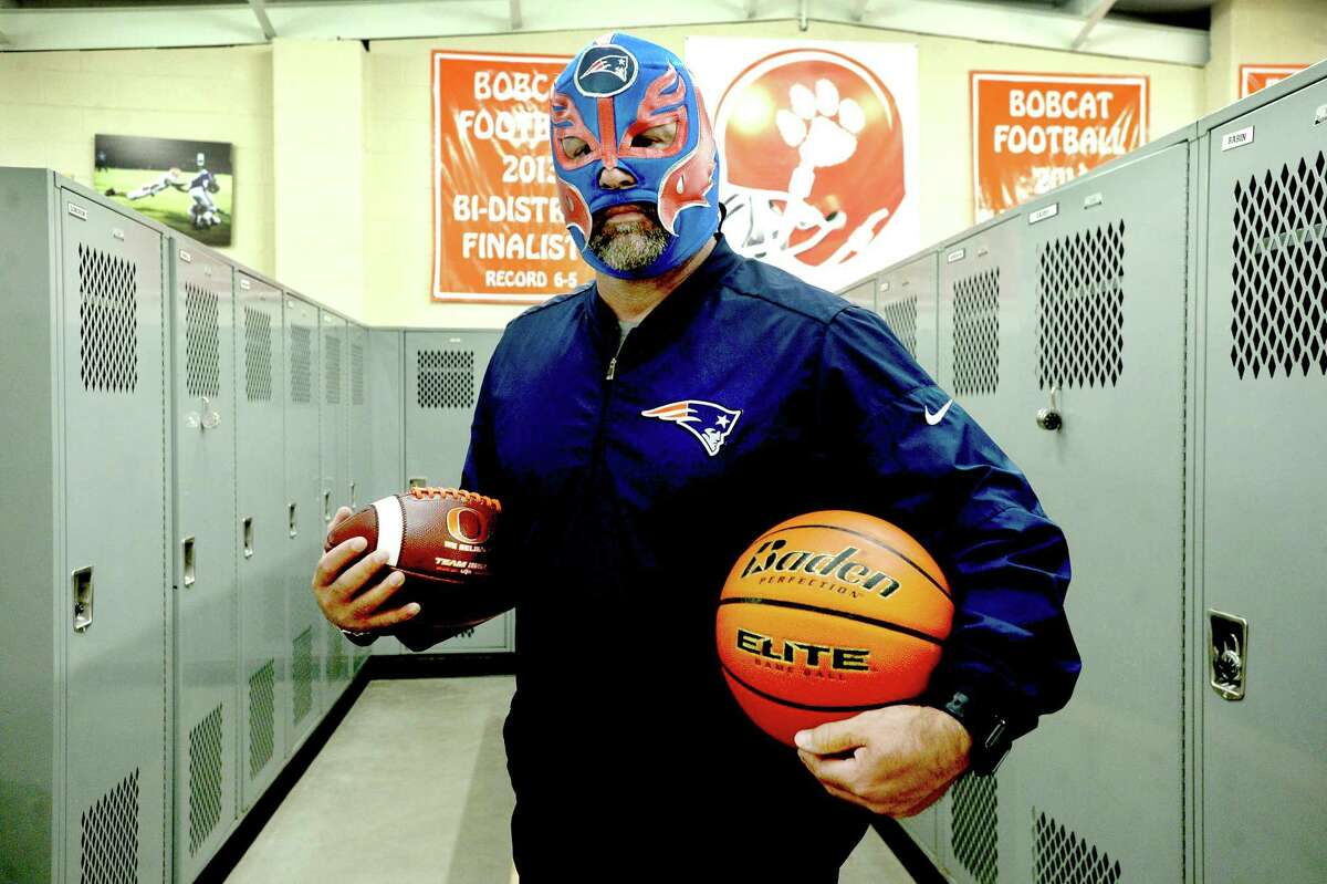 Orangefield coach Josh Smalley has tried to bring a little levity in dark times, transforming into El Patriota as he videos himself tending to the grounds and athletic facilities at the high school. A long-time New England Patriots fan, he'd received a gift of a Patriot's themed wrestling mask from a friend who'd found it during a trip to Cabo. He says he'll probably never hear the end of his in-character posts mid-quarantine, but if it makes somebody laugh while dealing with this, it's worth it. Photo taken Tuesday, May 19, 2020 Kim Brent/The Enterprise
