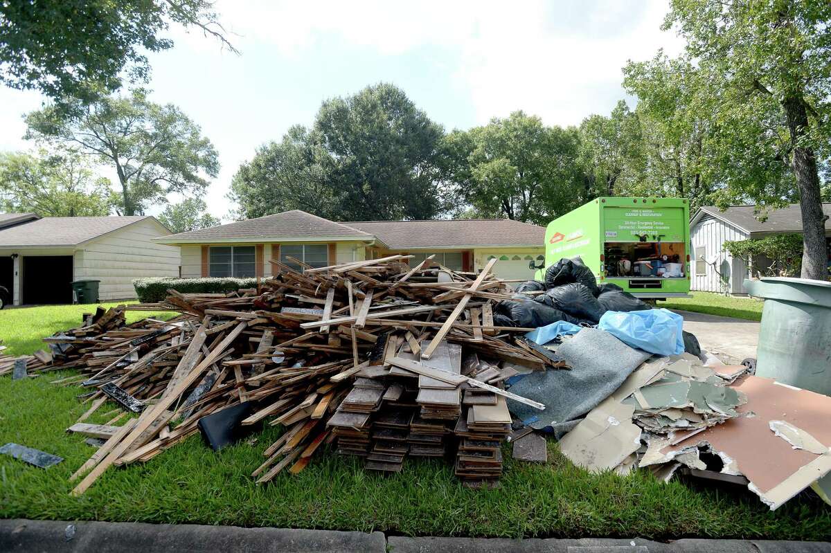 A large debris pile sits in front of a home on Morrogh Drive where a Servpro crew guts as residents throughout flooded Beaumont neighborhoods get to the work of gutting their damaged homes Tuesday. Photo taken Tuesday, September 24, 2019 Kim Brent/The Enterprise