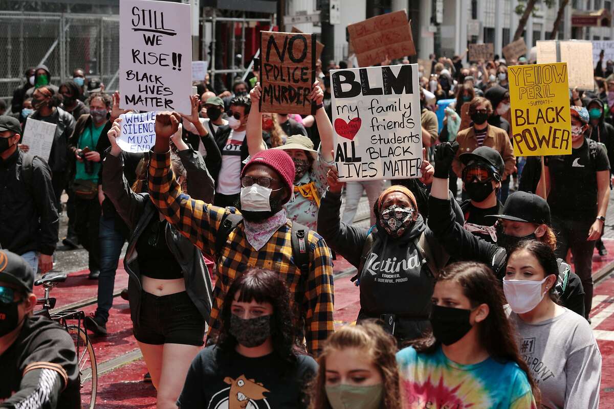 Protesters march along Market Street after a rally at City Hall on Saturday, May 30, 2020, in San Francisco, Calif. Protesters continued following the death of George Floyd, who died after being restrained by Minneapolis police officers on Memorial Day.