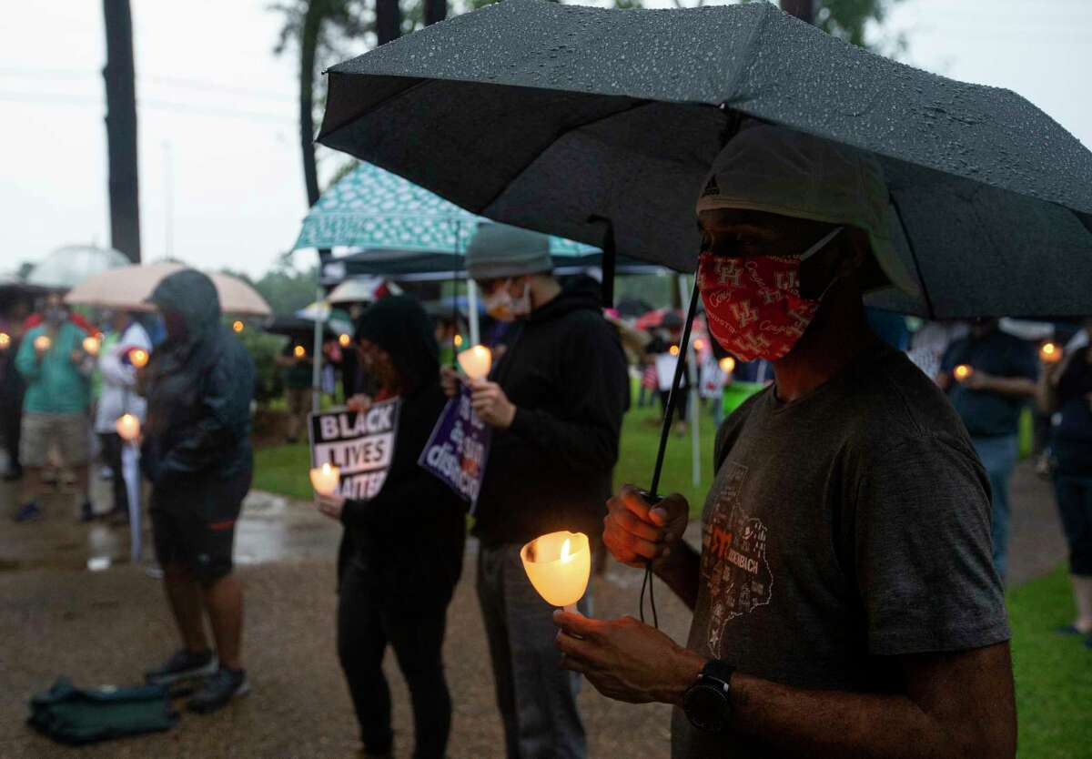 A large group of people show up in the rain to attend a vigil for George Floyd, who died in Minneapolis Police Department custody earlier this week, Sunday, May 31, 2020, at Metropolitan Community Church in Houston. The vigil held an eight-minute-and-46-seconds moment of silence, the time that white MPD officer, Derek Chauvin, kept his knee on Floyd's neck, to remember Floyd.