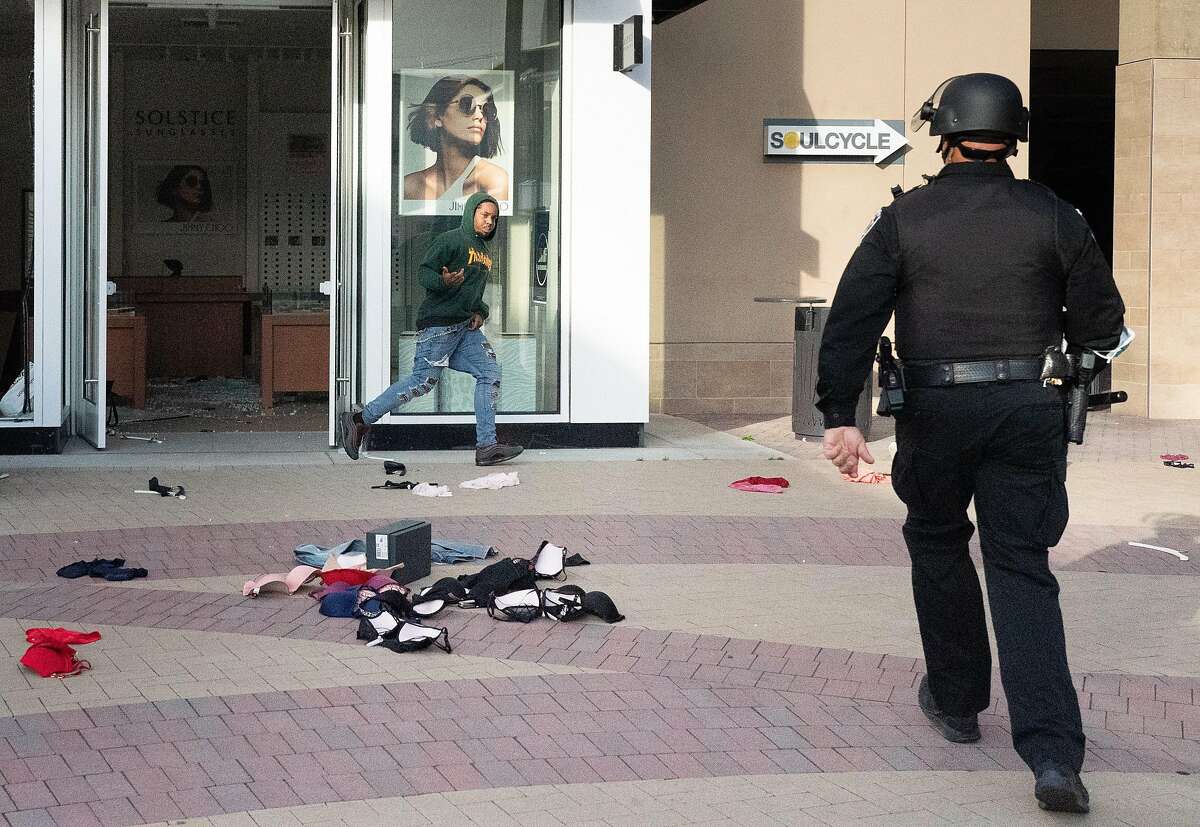 Police approach someone who was rummaging in a eyeglass store at the mall in Walnut Creek on Sunday, May 31, 2020 in Walnut Creek, Calif.