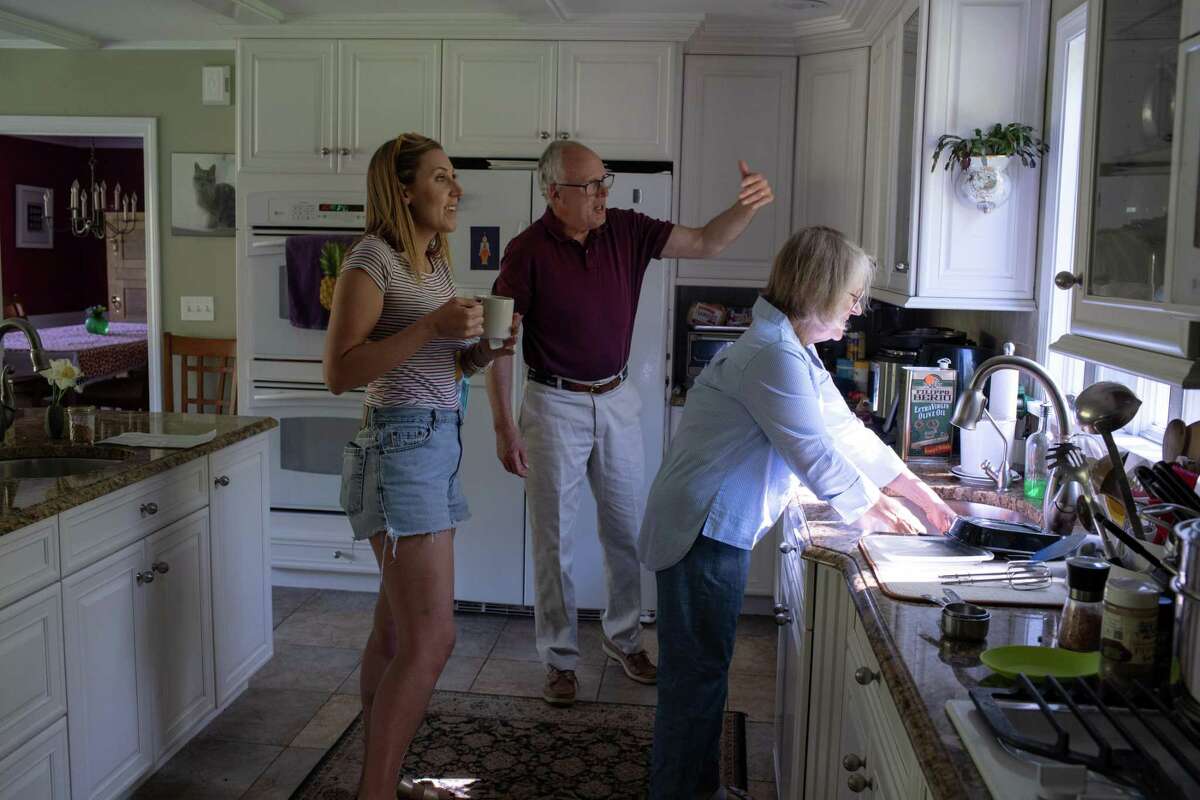 Blake Stelle, left, moved in with her parents Bruce, center, and Barbara Stelle, right, in New Hampshire.