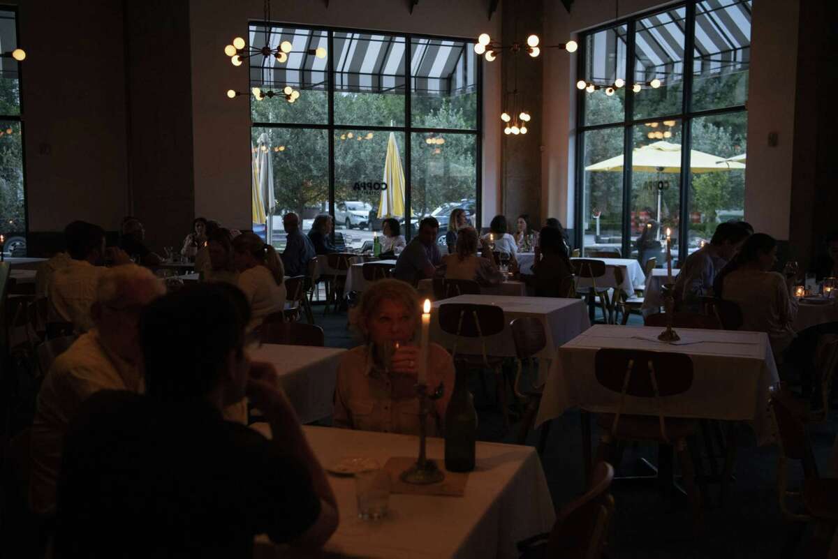 People dine at a restaurant after coronavirus restrictions were lifted in Houston on May 27, 2020.