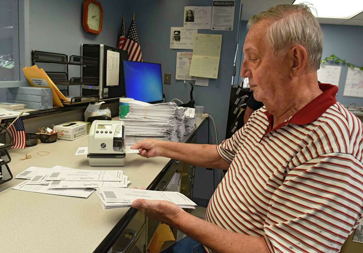 Custodian of Records Raymond Frankwski stamps the date and time on absentee ballots as Rensselaer County Board of Elections handles thousands of absentee ballots for June 23 primary on Monday, June 1, 2020 in Troy, N.Y. (Lori Van Buren/Times Union)