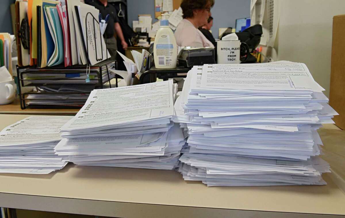 Filled out applications for absentee ballots are seen stacked on a desk as Rensselaer County Board of Elections handles thousands of absentee ballots for June 23 primary on Monday, June 1, 2020 in Troy, N.Y. (Lori Van Buren/Times Union)