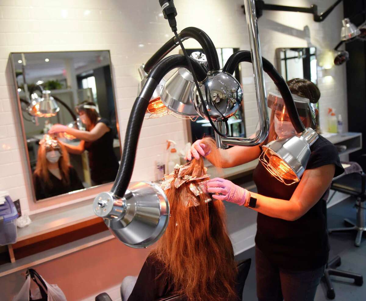 Roseanne Dicicco colors the hair of a loyal client at Hopscotch Salon in Old Greenwich, Conn. Monday, June 1, 2020. Barbershops, hair salons, and casinos in Connecticut were allowed to reopen with restrictions on Monday.