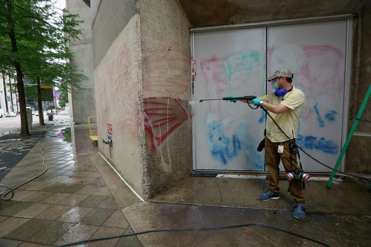 Alley Theatre employee Van Shannon spent Monday, June 1, 2020, removing graffiti off their wall along Louisiana between Texas and Prairie in downtown Houston. Over the weekend protesters defaced the walls with spray paint.