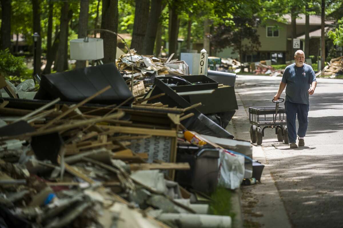 Clean up efforts after the flood continue on some of Midland's hardest hit streets Monday, June 1, 2020. City crews continue to make heavy item pickups to be delivered to the landfill. (Katy Kildee/kkildee@mdn.net)