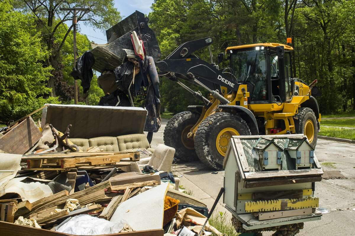 Clean up efforts after the flood continue on some of Midland's hardest hit streets Monday, June 1, 2020. City crews continue to make heavy item pickups to be delivered to the landfill. (Katy Kildee/kkildee@mdn.net)