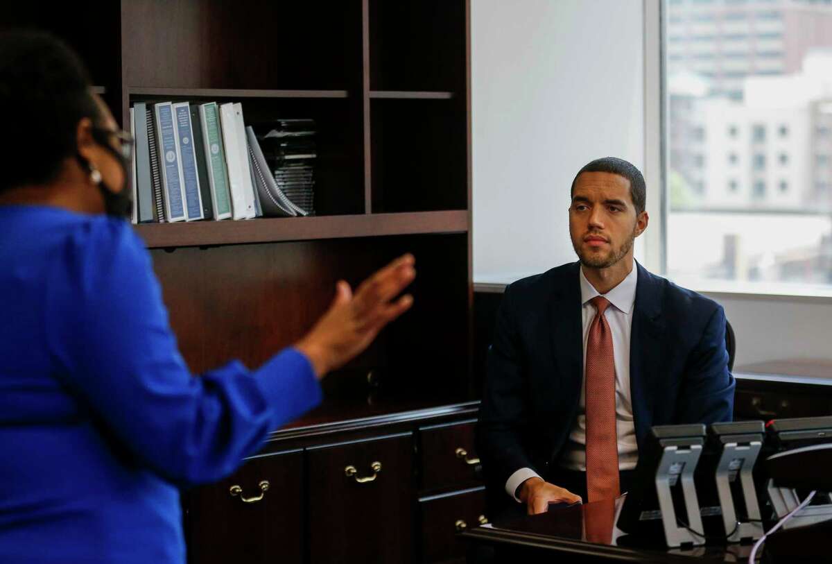 Interim Harris County clerk Chris Hollins, right, talks with chief deputy Teneshia Hudspeth, left, before getting on a video call in his new office at the Harris County Civil Courthouse building Wednesday, May 27, 2020, in Houston.