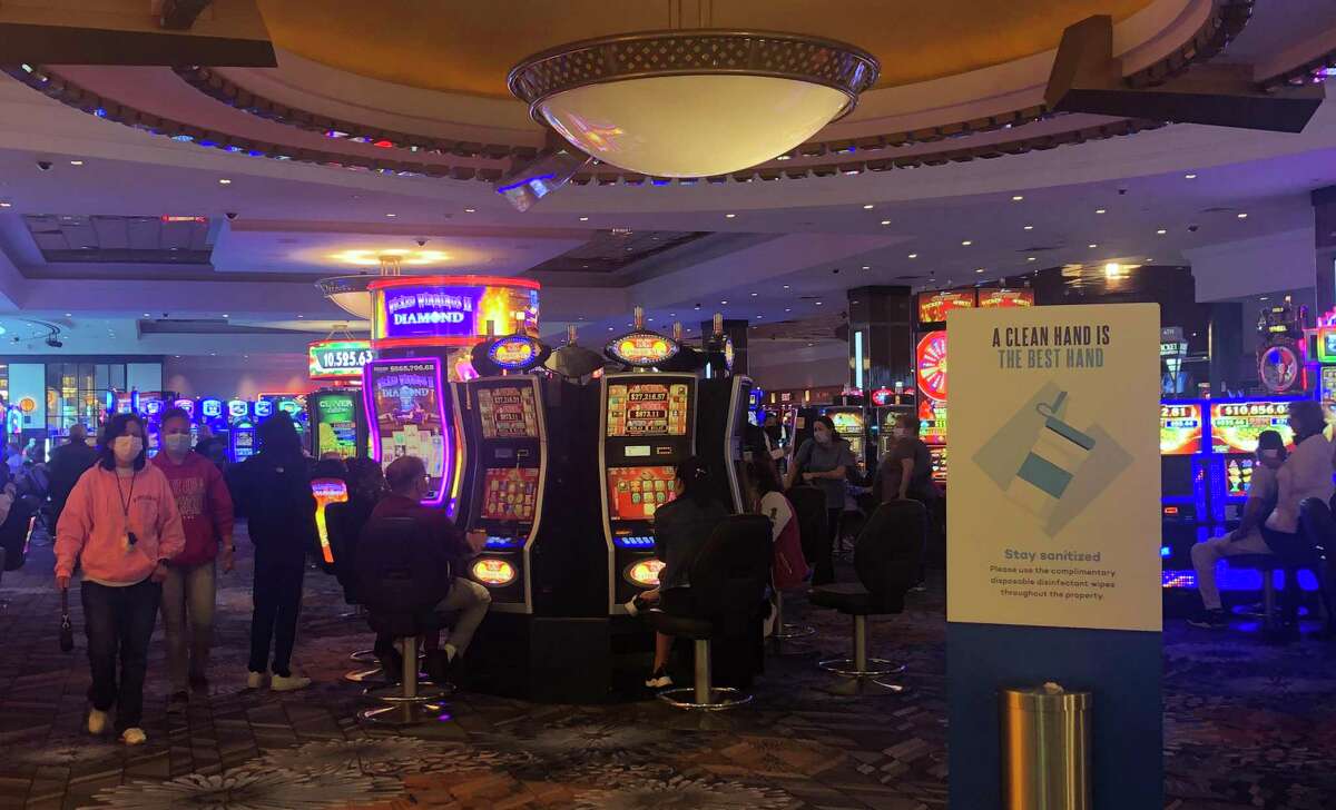 Patrons walk through the main gaming floor at the Foxwoods Resort Casino Monday June 1, 2020, the first day the state’s tribal-owned casinos reopened since they closed due to the COVID health threat.