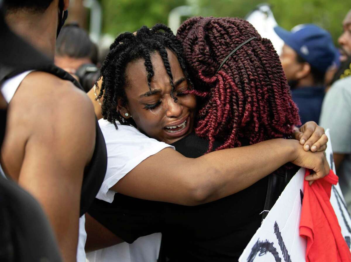 George Floyd's niece is embraced by demonstrators as she mourns the loss of her uncle who was killed earlier this week, on Saturday, May 30, 2020. The rally started at Emancipation Park and traveled to Houston City Hall where demonstrators were met with Houston's Police Department, Texas State Troopers and the National Guard.