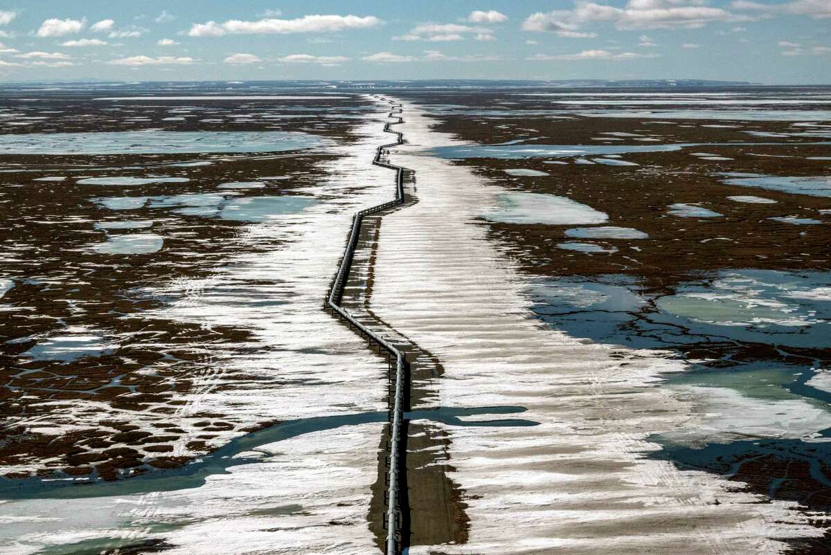 An oil pipeline stretches across the landscape outside Prudhoe Bay in North Slope Borough, Alaska.