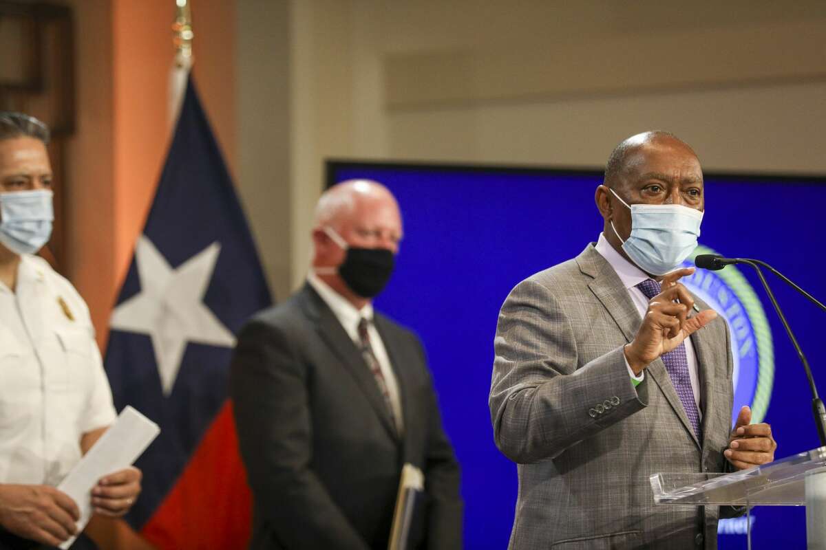 Houston Mayor Sylvester Turner, from right, Dr. David Persse, health authority for the City of Houston, and HFD Chief Samuel Pena are seen during a press conference Monday, June 1, 2020, at City Hall in Houston.
