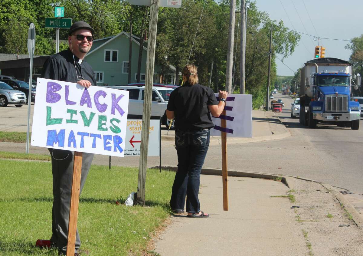 Rev. JT Hills and Devon Herrell stood outside the United Church of Big Rapids Tuesday morning, protesting in support of the Black Lives Matter movement.