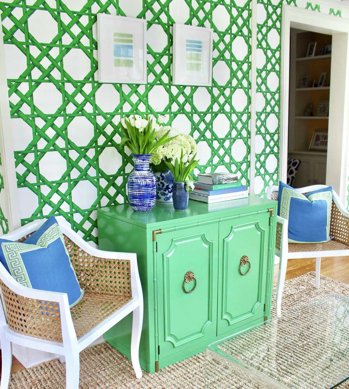 Blue and green are the standouts in this summer-inspired space, according to Kate Smith, owner of Kate Smith Interiors in Fairfield. “I love rehabbing vintage and antique finds, and this mid-century faux bamboo cabinet was custom painted in a cheerful green to set the color palette for the rest of the room,” she says.