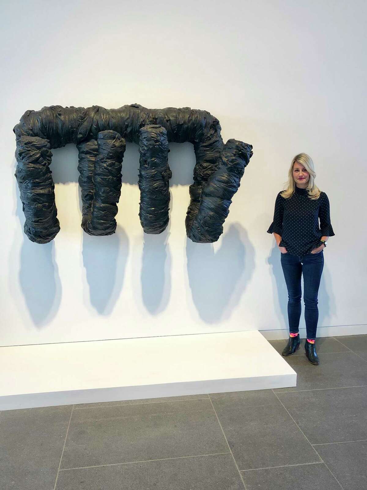 The Aldrich Contemporary Art Museum’s senior curator, Amy Smith-Stewart, poses with Harmony Hammond’s work “Kong.”