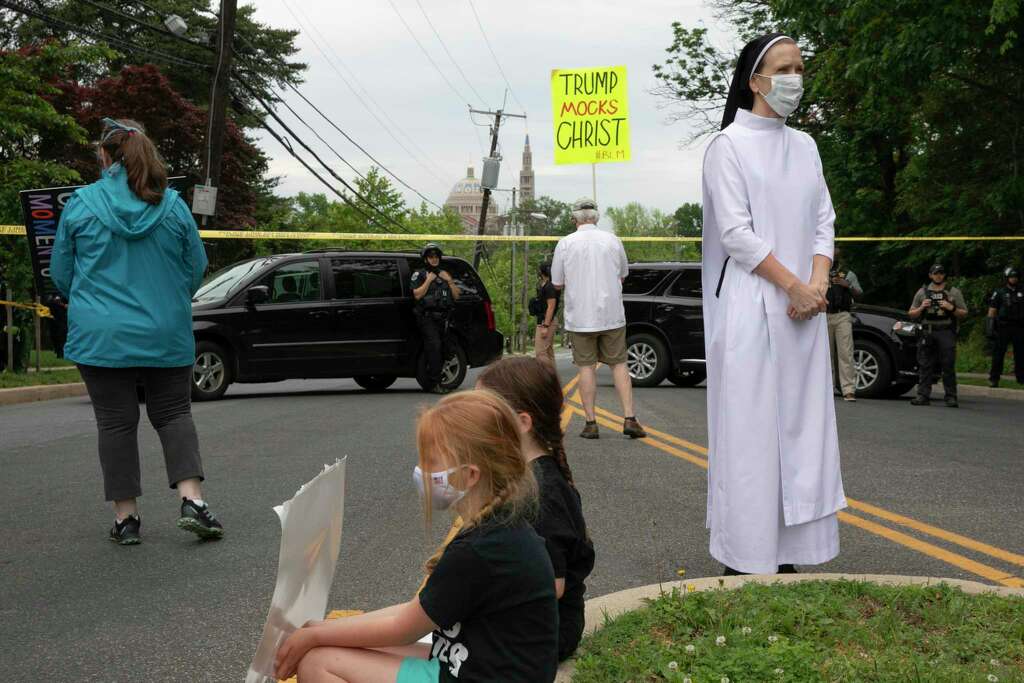 Sister Quincy Howard, right, a Dominican nun, arrives to protest the arrival of President Donald Trump to the Saint John Paul II National Shrine, Tuesday, June 2, 2020, in Washington. Many demonstrators said