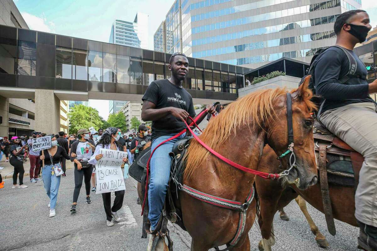 People join George Floyd’s family in a march on Tuesday, June 2, 2020, from Discovery Green to City Hall in downtown Houston.