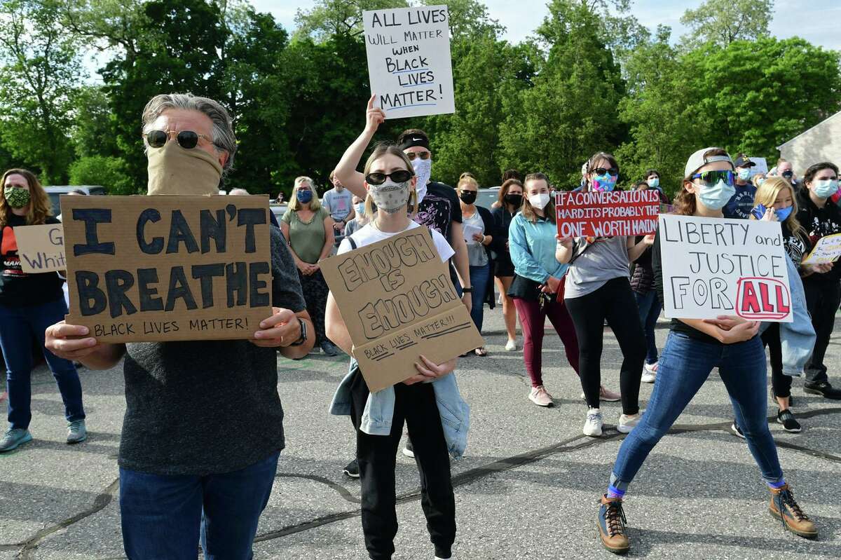 A crowd of near two hundred gather along route 7 at Our Lady of Fatima Catholic Church to protest police brutality and speak during an event at the church Tuesday, June 2, 2020, in Wilton, Conn. A march down the center of route 7 took place after the vigil at OLF in Wilton.