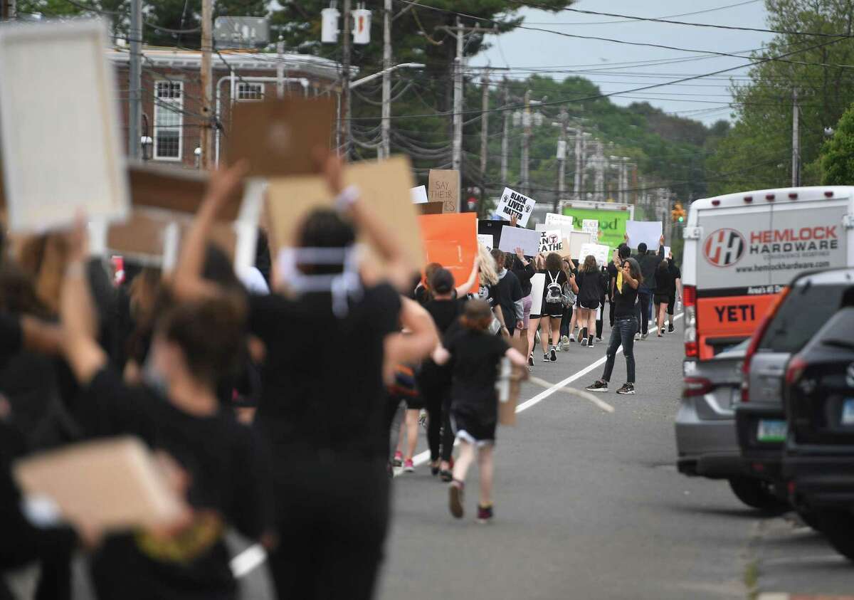 Protestors chant slogans while marching down the Post Road during an organized Black Lives Matter police brutality protest in Fairfield, Conn. on Tuesday, June 2, 2020.