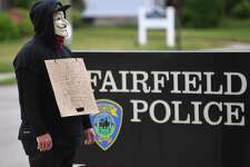 A Black Lives Matter protestor stands a solitary vigil outside the Fairfield Police Station during the protest in Fairfield, Conn. on Tuesday, June 2, 2020.