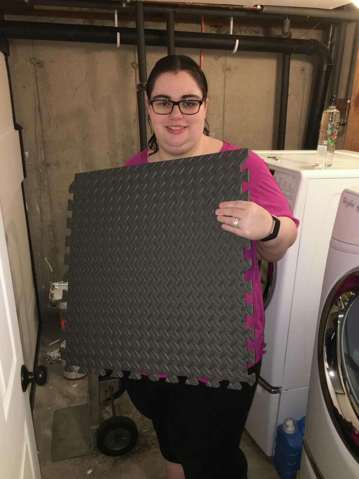 Nicole Zappone, writer, prepares to install a floor panel in her basement washroom. She and her husband, Nick, have been gradually renovating their home since they moved in in 2015. This latest project occurred while they were quarantined during the coronavirus.