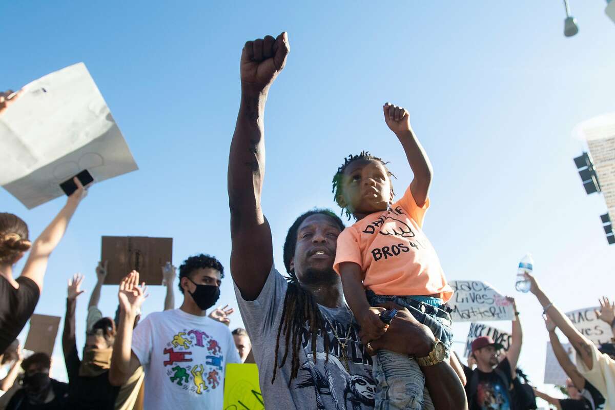 Father and son protesters during a demonstration following the death in Minnesota of George Floyd held Vallejo, Calif., Tuesday, June 2, 2020.