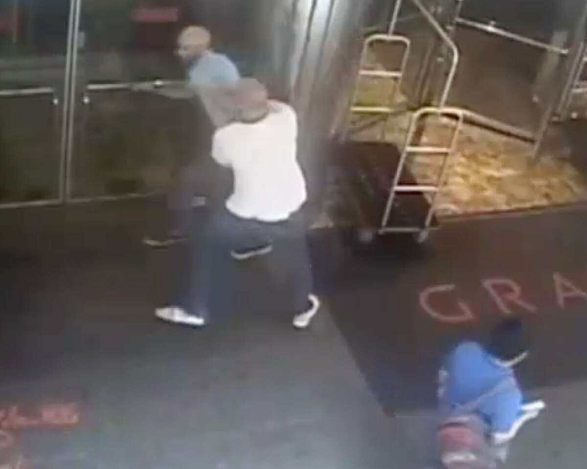 This image taken from a surveillance camera and released by the New York Police Department shows former tennis star James Blake, top left, being arrested by plainclothes officer James Frascatore outside of the Grand Hyatt New York hotel on Wednesday, Sept. 9, 2015, in New York. Blake was mistaken for an identity-theft suspect that Police Commissioner William Bratton said looked like Blake's "twin." Bratton apologized to Blake. (NYPD via AP)