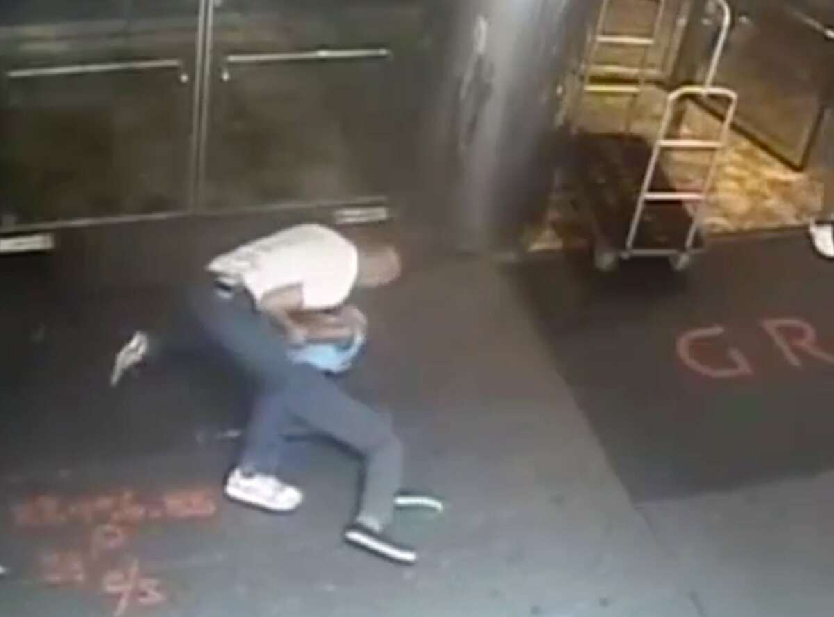 This image taken from a surveillance camera and released by the New York Police Department shows former tennis star James Blake, right, being arrested by plainclothes officer James Frascatore outside of the Grand Hyatt New York hotel on Wednesday, Sept. 9, 2015, in New York. Blake was mistaken for an identity-theft suspect that Police Commissioner William Bratton said looked like Blake's "twin." Bratton apologized to Blake. (NYPD via AP)