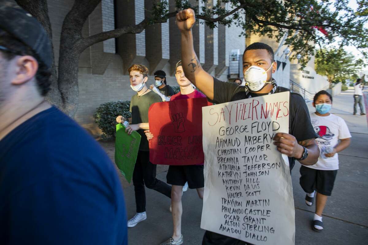Protestors march outside the Midland Police Department Tuesday, June 2, 2020 at 610 North Loraine Street.