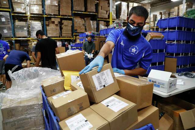 Ammar Dukka packs orders to be shipped out at Ionized LLC, a Sugar Land glow stick manufacturer that is now importing PPE from China for Harris County, on Tuesday, May 26, 2020 in Sugar Land.