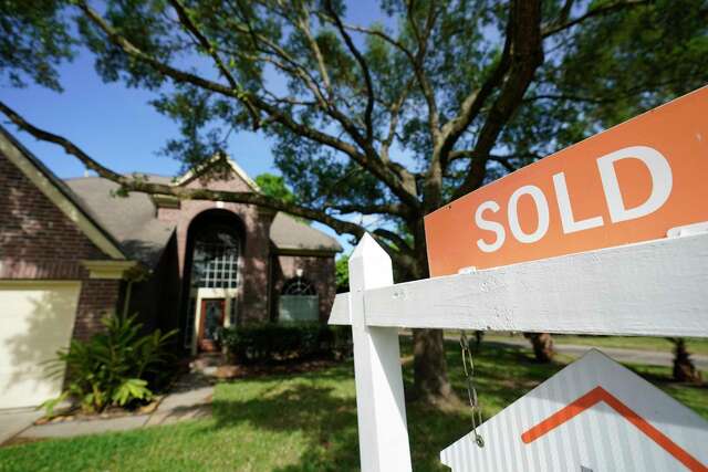 A sold sign is shown on a real estate sign outside a home Tuesday, March 31, 2020, in Spring.