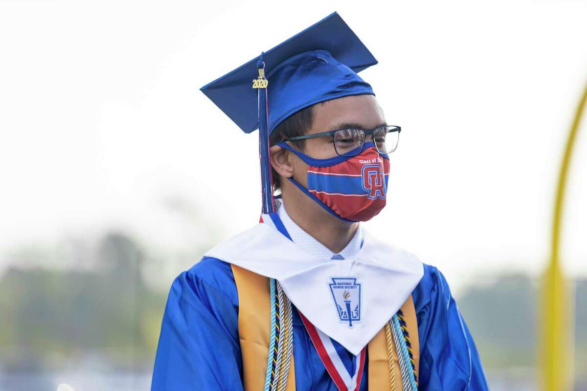 Jose Wui listens to classmates before a Oak Ridge High School graduation ceremony at Woodforest Bank Stadium in Shenandoah, Wednesday, June 3, 2020. Ceremonies were split with a 8 a.m. and 8 p.m. time slots to allow 6 feet distancing between graduates.