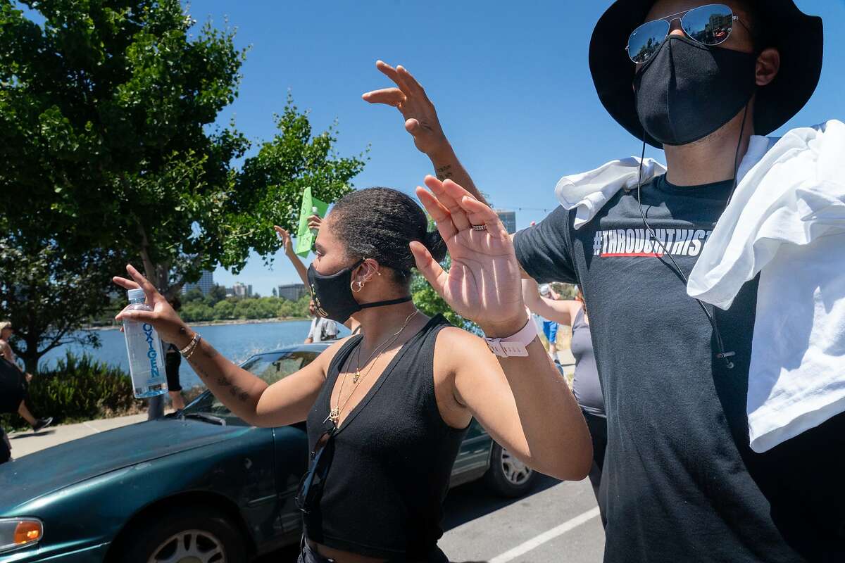 Stephen Curry with wife Ayesha march around Lake Merrit with other Warriors like Klay Thompson, Kevon Looney, and Damion Lee protest the killing of George Floyd by Minneapolis Police on Wednesday, June 3, 2020 in Oakland, Calif.