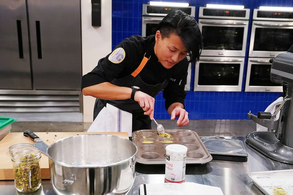 San Francisco chef Melissa King spoons batter for olive oil pistachio cake into molds during a "Top Chef: All-Stars L.A." quick-fire challenge.