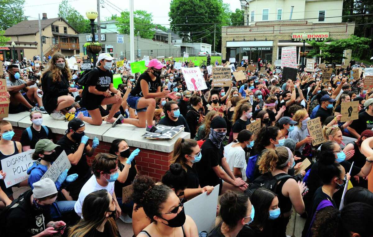 Hundreds of people take a knee to protest police brutality in ffront of the police station in Danbury, Conn., on Wednesday June 3, 2020. The protest was one of dozens all over the country after the death of George Floyd in Minneapolis.