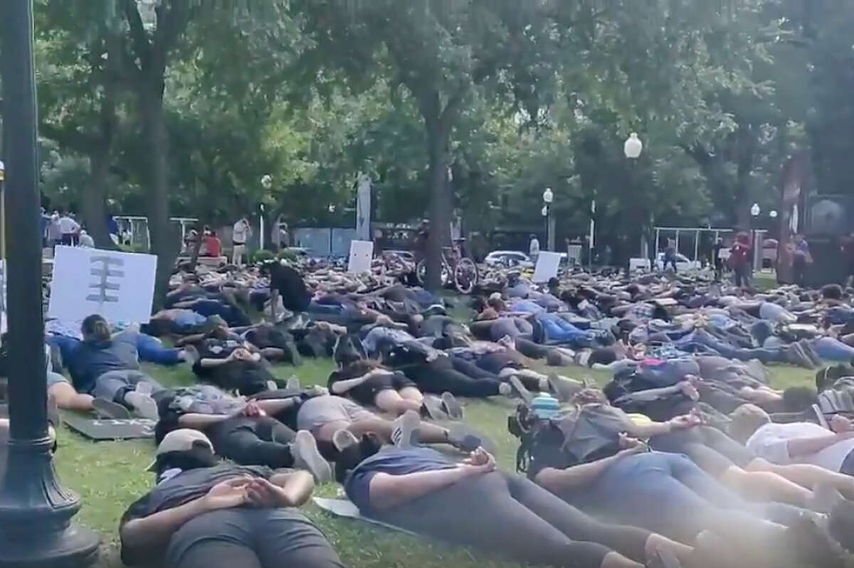 Protesters in Travis Park chanting "I can't breath" on the floor with their hands behind their backs during the fifth day of protests Wednesday afternoon, June 3, 2020, over the death of George Floyd.
