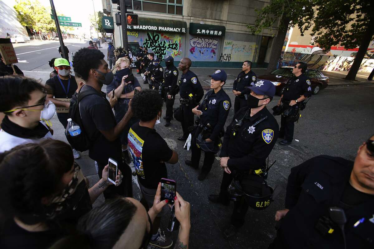 Several young demonstrators engaged with police at a roadblock on Broadway in a solidarity protest against police brutality and the killing of black citizens in Oakland, Calif., on Tuesday, June 2, 2020. Protests have happened for days following the death of George Floyd in Minneapolis at the hands of police.