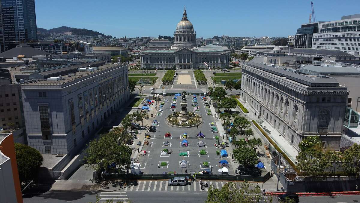 The homeless encampment along Fulton Street at the Civic Center on Saturday, May 23, 2020, in San Francisco, Calif. The city-sanctioned homeless encampment was set in place during the coronavirus pandemic. Social distancing rectangles drawn on the floor are an attempt to curb the spread of coronavirus.