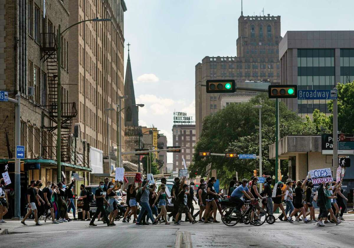 People protesting the death of George Floyd march Wednesday, June 3, 2020, toward Travis Park in downtown San Antonio. Floyd died in police custody May 25, 2020 in Minneapolis, Minnesota after a police officer was seen kneeling on his neck for more than 8 minutes. The death has sparked nationwide protests.