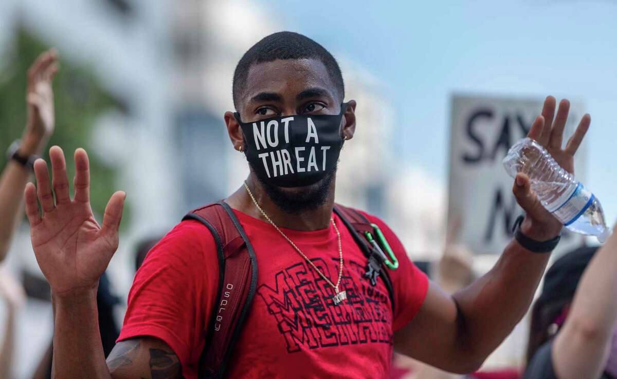 A person protesting the death of George Floyd marches Wednesday, June 3, 2020, around the county courthouse in downtown San Antonio. Floyd died in police custody May 25, 2020 in Minneapolis, Minnesota after a police officer was seen kneeling on his neck for more than 8 minutes. The death has sparked nationwide protests.