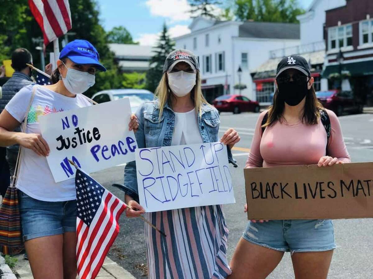 “No Justice No Peace”, “Stand up Ridgefield” and “Black lives matter” say signs at the protest in front of town hall last Sunday.