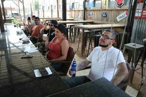 Patrons at Bentley's Beer Garden relax on swings as bars in San Antonio as well as across Texas reopen on Friday, May 22, 2020. State rules for their re-opening require them to operate at 25 percent capacity, have patrons sit at tables with a six per person limit and dancing or other close-contact is discouraged.