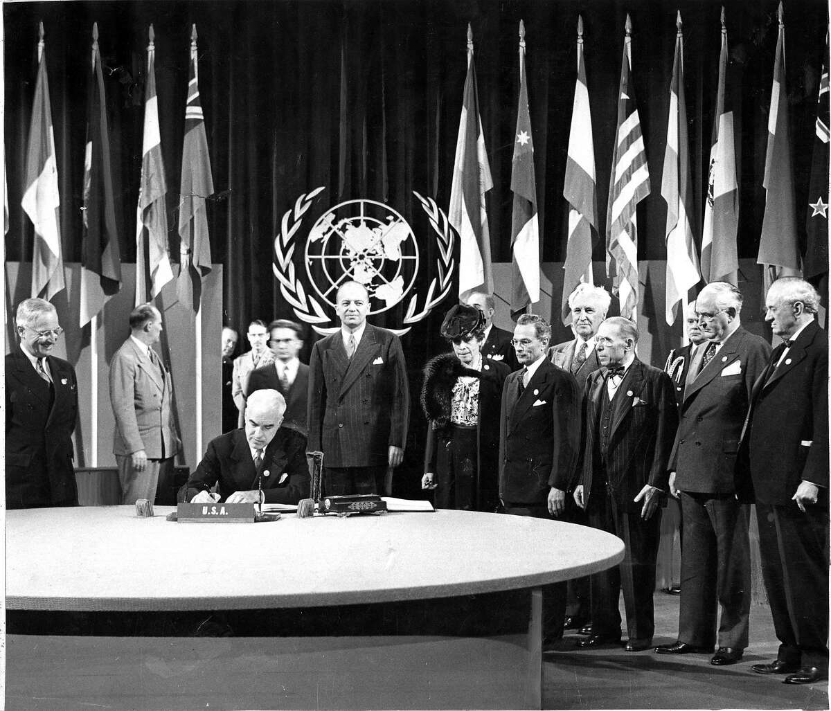 United Nations Charter Signing President Harry Truman watches as Secretary of State Stettinious signs the World Charter for the United States Photo ran 06/27/1945, Pg 1 No credit information