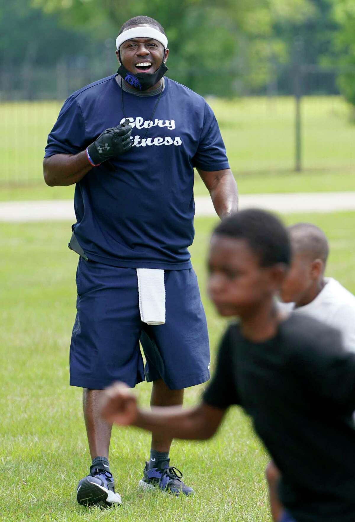 Christopher Boykins, who started the Boykins Youth Foundation that brings exercise to kids in the Houston area, leads a workout at Tom Bass Park Monday, May 4, 2020, in Houston. He has owned and operated Glory Fitness since 2006, which has been closed amid the Covid-19 pandemic.