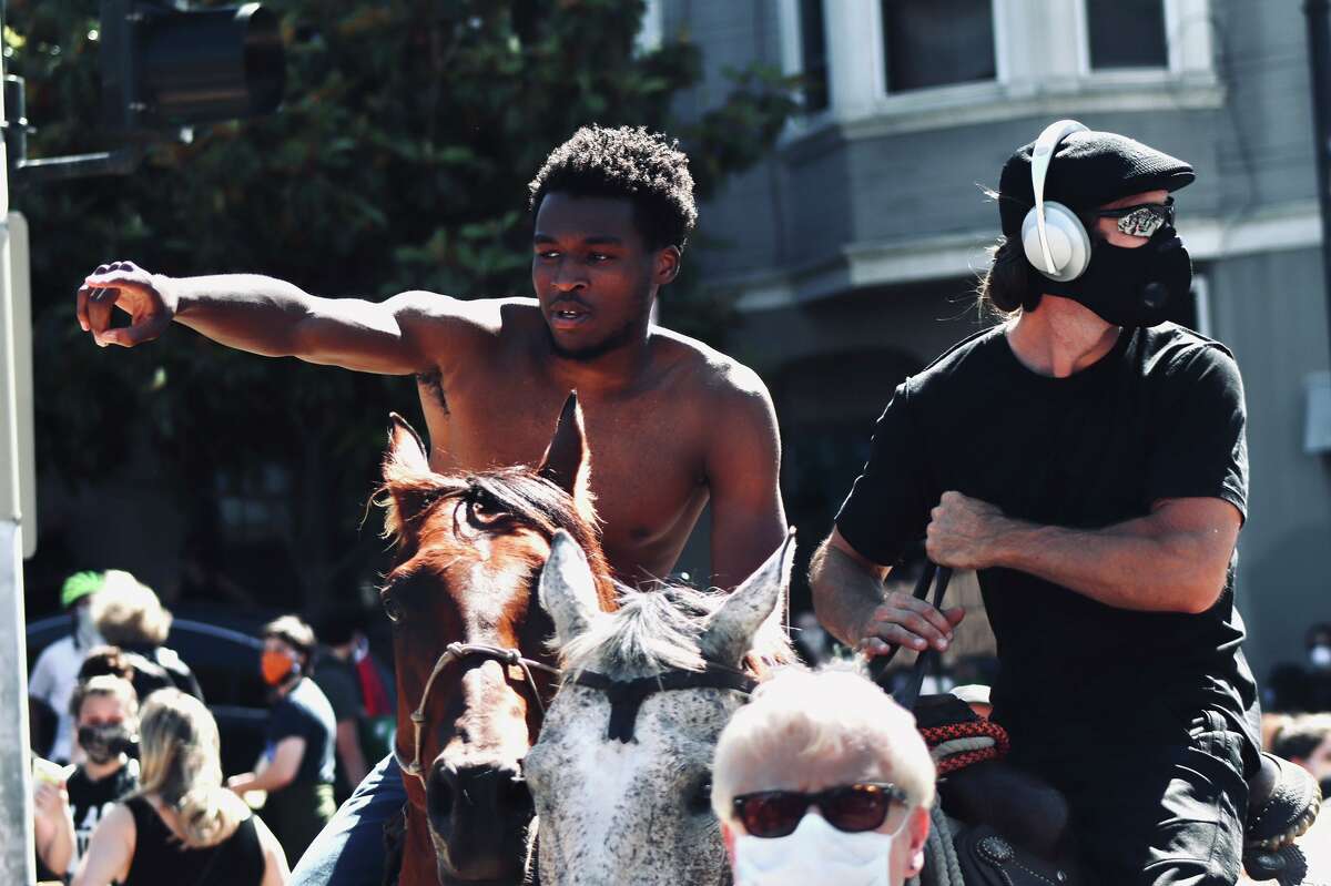 “So, I asked to get on and he let me,” he told SFGATE on Thursday afternoon. “It felt great to ride — it was only my third time riding a horse in my life.” The protest, led by grassroots organization No Justice No Peace SF, amassed an unofficial estimate of 10,000 people, though KTVU estimates the crowd could have been as large as 12,000 to 16,000. Organizers guessed as many as 30,000 people gathered for the peaceful demonstration that day, and several students were in attendance to pass out water bottles, snacks and hand sanitizer. Anigbogu led several chants on horseback as the crowd marched from Mission High School to the district police station on Valencia Street, and even through Dolores Park. People observing from sidewalks and rooftops gawked as they took photos and cheered them on. They even captured the attention of Mythbusters' Adam Savage, who was present at the march. It was the first time the horses, aged 3 and 11, had participated in such a demonstration, and they appeared to be relatively calm despite sweltering temperatures and a boisterous crowd.