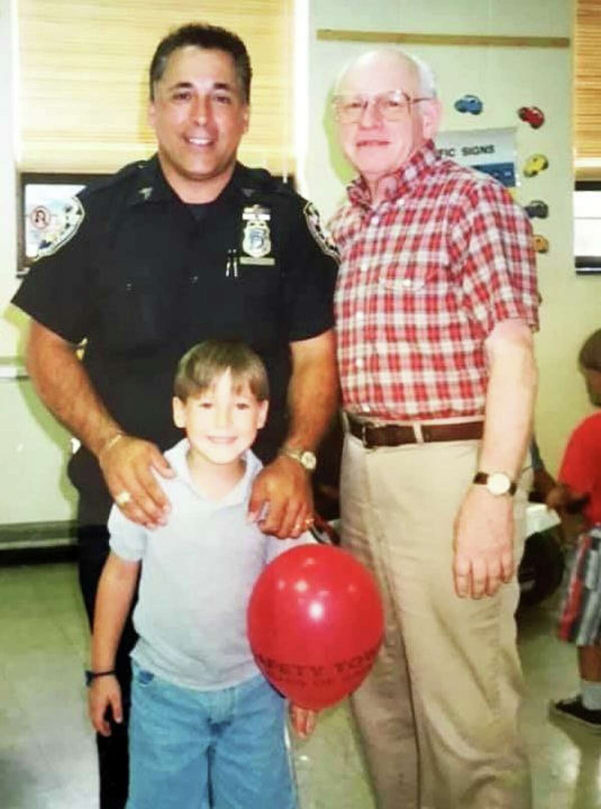 Middletown Common Council Minority Leader Phil Pessina, left, and the late Clayton Hewitt, right, a former Middletown police officer, are shown with Hewitt’s grandson during the late 1970s to early 1980s during a Safety Town graduation.