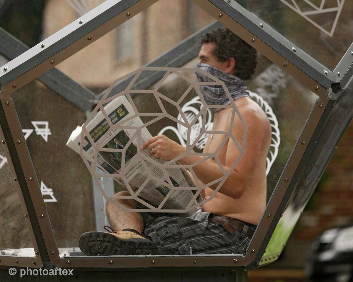 In his “Artist Self-Quarantine,” fine artist Vincent Fink reads a newspaper inside his Dodecahedron sculpture on Heights Boulevard in Houston as public performance art. The exhibit is a reflection on the isolation brought on by the COVID-19 pandemic.