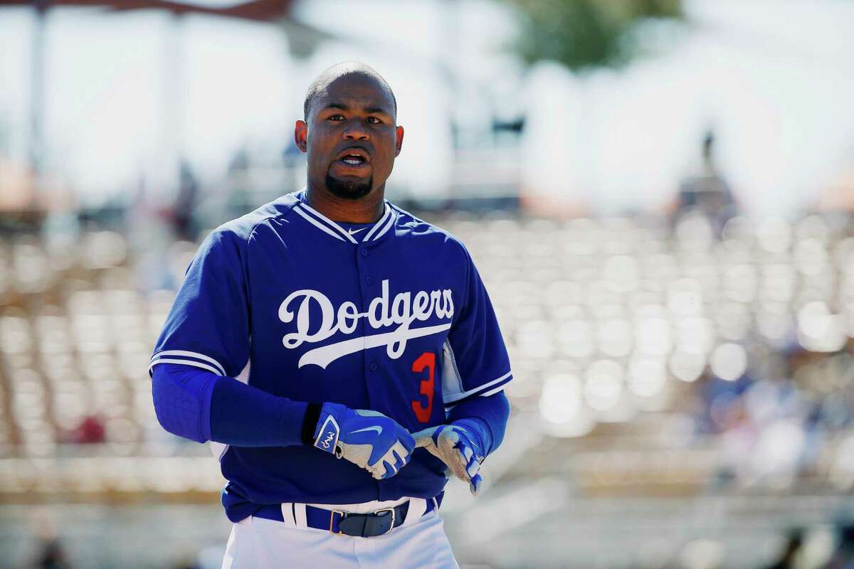 FILE - In this March 4, 2015, file photo, Los Angeles Dodgers' Carl Crawford walks back to the dugout in the third inning of a spring training exhibition baseball game against the Chicago White Sox in Phoenix. Houston police were called Saturday, May 16, 2020, for a reported drowning of a boy and a woman at a north Houston home that property and business records list as belonging to Crawford, The Houston Chronicle reported Saturday. (AP Photo/John Locher, File)